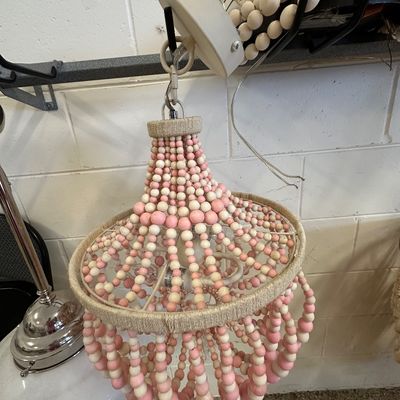 Sale Photo Thumbnail #123: Boho-style light fixture featuring strands of pink and white wooden beads arranged in an empire shape with jute-wrapped wire hoops.