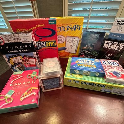 Sale Photo Thumbnail #53: Collection of modern board games and card games, including Pictionary, Friends Trivia, What Do You Meme?, and The Chameleon.