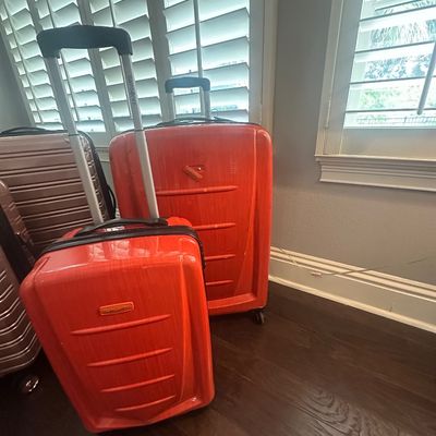 Sale Photo Thumbnail #72: Two-piece Samsonite bright orange hardside spinner luggage set featuring a carry-on and checked size suitacase.