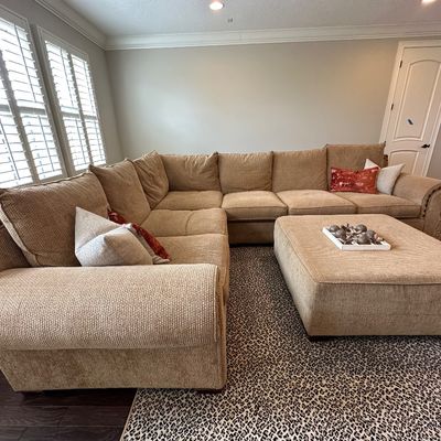 Sale Photo Thumbnail #28: Large contemporary beige textured fabric sectional sofa with nailhead trim detailing, matching oversized ottoman, and accent pillows.