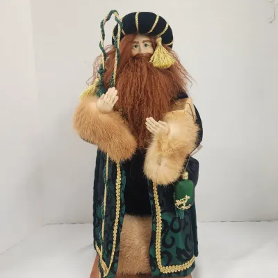 Sale Photo Thumbnail #276: LYNN HANEY Handcrafted Father Christmas Santa figure dressed in a green velvet coat with faux fur trim and gold metallic accents, mounted on a wooden base.