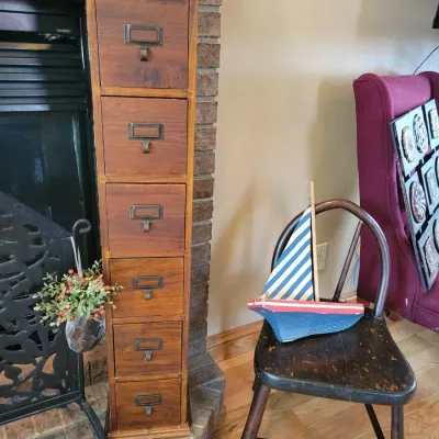 Sale Photo Thumbnail #49: Tall library style cabinet, childs chair and wooden boat 