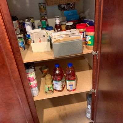 Sale Photo Thumbnail #22: Wooden pantry cabinet filled with various non-perishable food items, canned goods, condiments, and recipe file boxes.