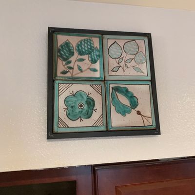 Sale Photo Thumbnail #25: Framed four-tile ceramic wall art piece featuring teal and green hand-painted botanical motifs.
