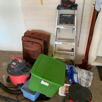Sale Photo Thumbnail #52: Collection of garage utility items, including a Craftsman shop vac, plastic storage totes, a rolling brown suitcase, an aluminum stepladder, and a red rolling step stool.