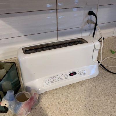 Sale Photo Thumbnail #19: White Cuisinart long-slot 2-slice toaster sitting on a kitchen countertop.