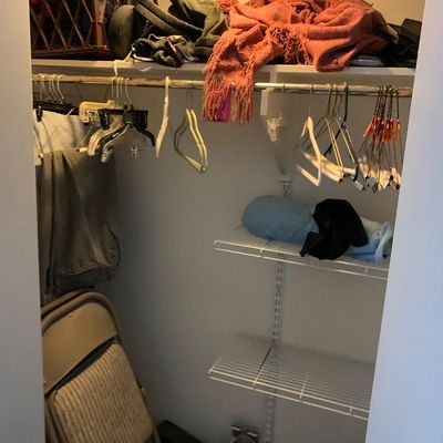 Sale Photo Thumbnail #89: Closet filled with assorted household items including clothes hangers, folded linens, bags, and a beige padded folding chair.