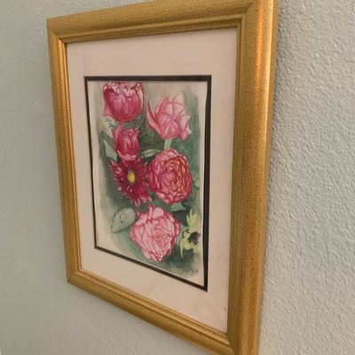 Sale Photo Thumbnail #123: Framed floral watercolor painting featuring pink blossoms, mounted in a double mat and a textured gold-toned wooden frame.