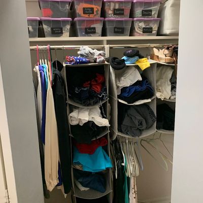 Sale Photo Thumbnail #119: Organized closet featuring labeled plastic storage bins with purple lids, hanging fabric organizers, and various women's clothing and accessories.