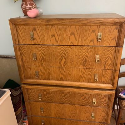Sale Photo Thumbnail #106: Vintage tall oak dresser featuring brass drop handles and five long drawers.