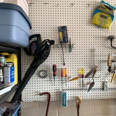 Sale Photo Thumbnail #55: Workshop pegboard featuring various hand tools, screwdrivers, a crowbar, and an electric leaf blower.