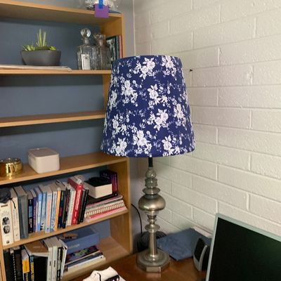 Sale Photo Thumbnail #65: Traditional pewter-finish metal table lamp topped with a blue and white floral patterned fabric shade.