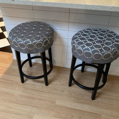 Sale Photo Thumbnail #13: Pair of modern backless counter-height bar stools with black wooden legs and patterned grey fabric upholstered seats.