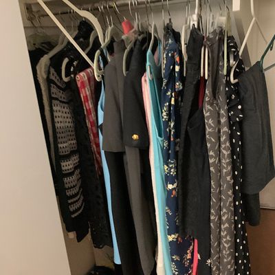 Sale Photo Thumbnail #118: Closet full of women's clothing on hangers, featuring a variety of patterned and solid tops, dresses, and sweaters.