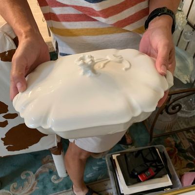 Sale Photo Thumbnail #129: Vintage white ceramic or porcelain covered tureen lid, featuring scalloped edges and a decorative molded finial.