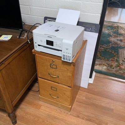 Sale Photo Thumbnail #64: White Epson EcoTank printer resting on a two-drawer light oak filing cabinet.