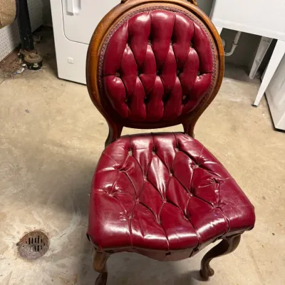 Sale Photo Thumbnail #11: Vintage Victorian-style carved wooden side chair featuring deep tufted burgundy vinyl or leather upholstery and cabriole legs.