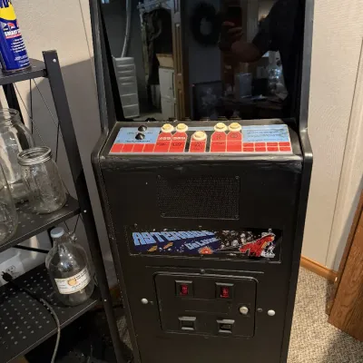 Sale Photo Thumbnail #3: Vintage Atari Asteroids Deluxe upright arcade cabinet featuring original control panel graphics and coin door.