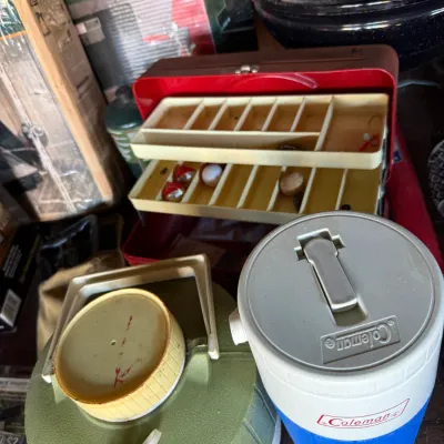 Sale Photo Thumbnail #36: Vintage Coleman water jugs, a red tackle box with fold-out trays, and outdoor camping equipment.