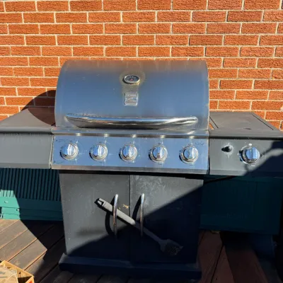 Sale Photo Thumbnail #47: Broilmate five-burner stainless steel and black outdoor gas grill with side burner.
