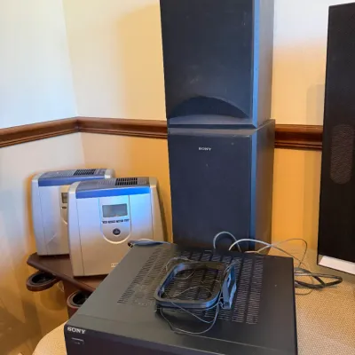 Sony audio/video control center receiver accompanied by stacked Sony black cabinet speakers, circa late 1990s.