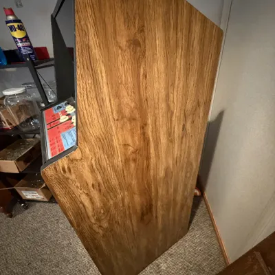 Sale Photo Thumbnail #4: Vintage arcade or gaming cabinet with faux wood-grain vinyl side panels and colorful control interface.