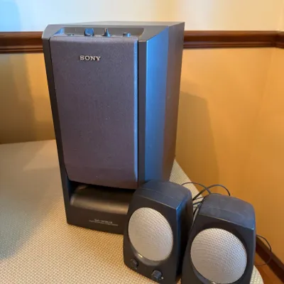 Sony SA-W303 powered subwoofer paired with two Cambridge SoundWorks satellite desktop speakers.