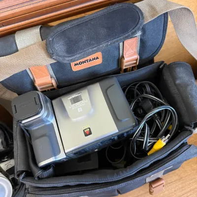 Sharp Viewcam 8 LCD camcorder model VL-E750 packed in a black and tan Montana padded shoulder bag alongside associated AV cables.