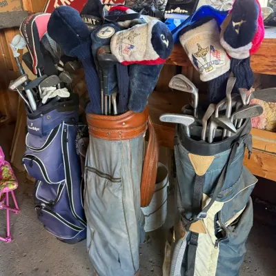 Sale Photo Thumbnail #28: Collection of three golf stand and cart bags filled with assortment of vintage and modern clubs and headcovers.