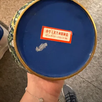 Sale Photo Thumbnail #15: Underside of a vintage cloisonné piece featuring a blue enamel base and a red 'Made in the People's Republic of China' sticker.