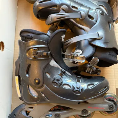 Sale Photo Thumbnail #8: Pair of Rollerblade Bio Dynamic inline skates featuring a hard shell outer boot, ABEC 3 bearings, and adjustable buckles, shown inside their original box.