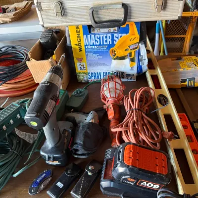 Sale Photo Thumbnail #41: Assortment of power tools, extension cords, and accessories, including a cordless drill, Black & Decker battery charger, and Wagner paint sprayer in box.