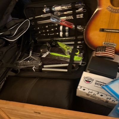 Sale Photo Thumbnail #48: Collection of household items including an open BBQ tool set in a case, a sunburst acoustic guitar, and a BigMouth Inc. stainless steel super flask in box.