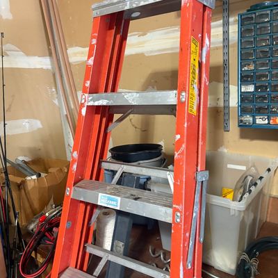 Sale Photo Thumbnail #37: Orange Master Mechanic fiberglass stepladder featuring aluminum rungs and showing paint splatters and light cosmetic wear.