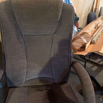 Sale Photo Thumbnail #132: Contemporary high-back office chair with dark gray fabric upholstery and padded armrests.
