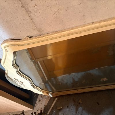Sale Photo Thumbnail #107: French Provincial style dresser mirror featuring an off-white cream frame with gold trim detailing and carved floral accents.