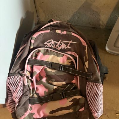 Sale Photo Thumbnail #114: Eastsport brand backpack featuring a pink and brown camouflage pattern with side mesh pockets and front utility straps.