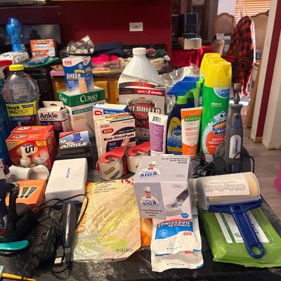 Sale Photo Thumbnail #77: Large assortment of household supplies, including cleaning sprays, medical bandages, a Dremel rotary tool, and personal care items.