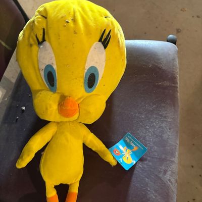 Sale Photo Thumbnail #112: Vintage Tweety Bird plush doll with original tag, showing significant dust and light soil on the head.