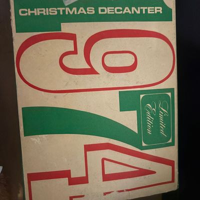 Sale Photo Thumbnail #65: Vintage 1974 Limited Edition Christmas Decanter original box featuring bold red and green graphic typography.
