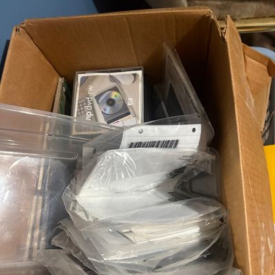 Sale Photo Thumbnail #22: Cardboard box filled with assorted CDs, DVDs, media cases, and plastic storage sleeves.