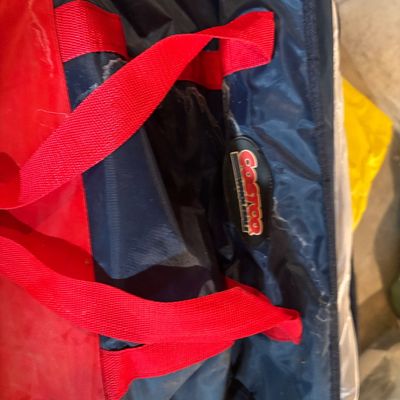 Sale Photo Thumbnail #125: Costco Wholesale insulated cooler bag featuring red and navy nylon fabric with webbed handles.