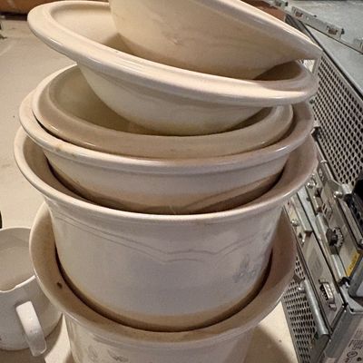 Sale Photo Thumbnail #129: Stack of vintage ceramic slow cooker replacement liners and lids in off-white, featuring subtle floral patterns.