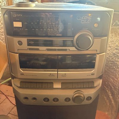 Sale Photo Thumbnail #94: Vintage GPX silver shelf stereo system featuring a CD player, dual cassette decks, AM/FM tuner, and CD+G karaoke functionality.