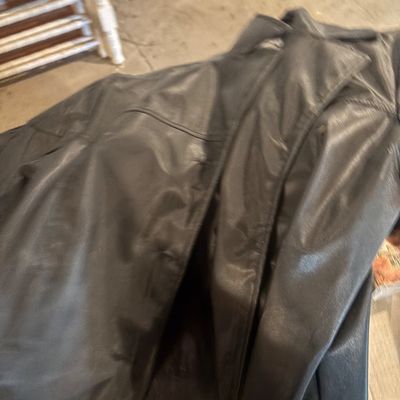 Sale Photo Thumbnail #123: Black leather coat with a notch lapel and lined interior.