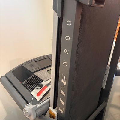 Sale Photo Thumbnail #28: Horizon Fitness Elite 3200 folding treadmill shown in a folded position, featuring a digital console with built-in speakers and safety clip.