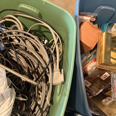 Sale Photo Thumbnail #110: Two plastic storage bins filled with vintage computer cables, power cords, and packaged electronics accessories.