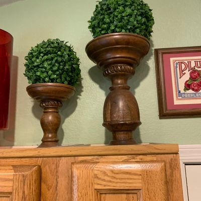 Sale Photo Thumbnail #71: Pair of turned wooden pedestal planters with artificial boxwood topiary balls in varying heights.
