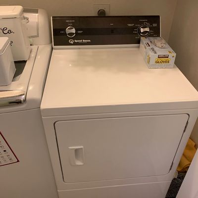 Sale Photo Thumbnail #84: White Speed Queen commercial heavy-duty dryer with a black control panel and mechanical dial controls.