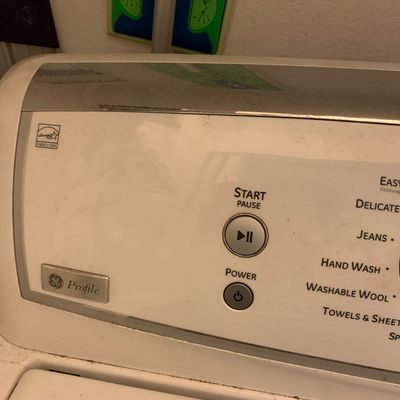 Sale Photo Thumbnail #82: GE Profile top-loading washing machine showing the control panel with digital settings.